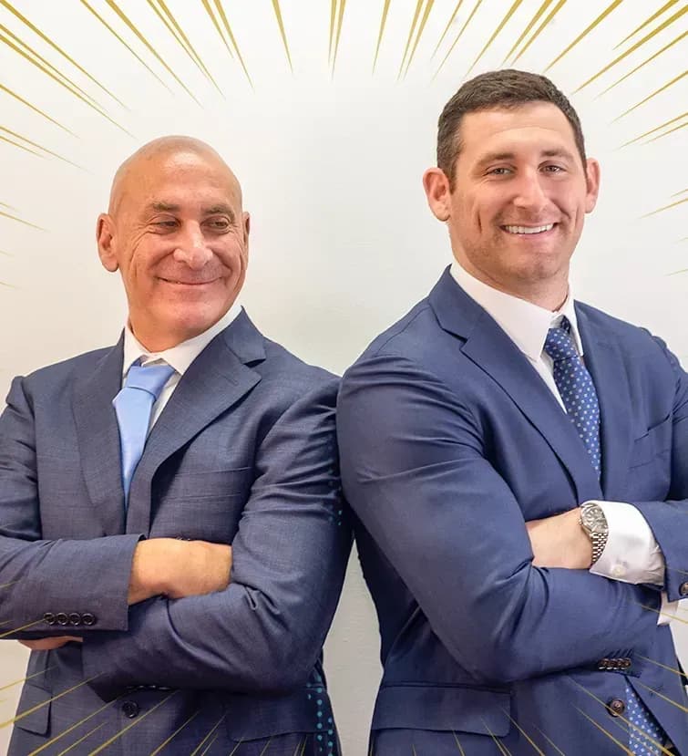  Senft Legal home insurance lawyers Scott and Alex Senft standing back to back, crossing their arms and smiling.