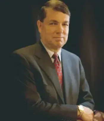 Personal injury lawyer R. Jack Clapp smiling with arms folded.